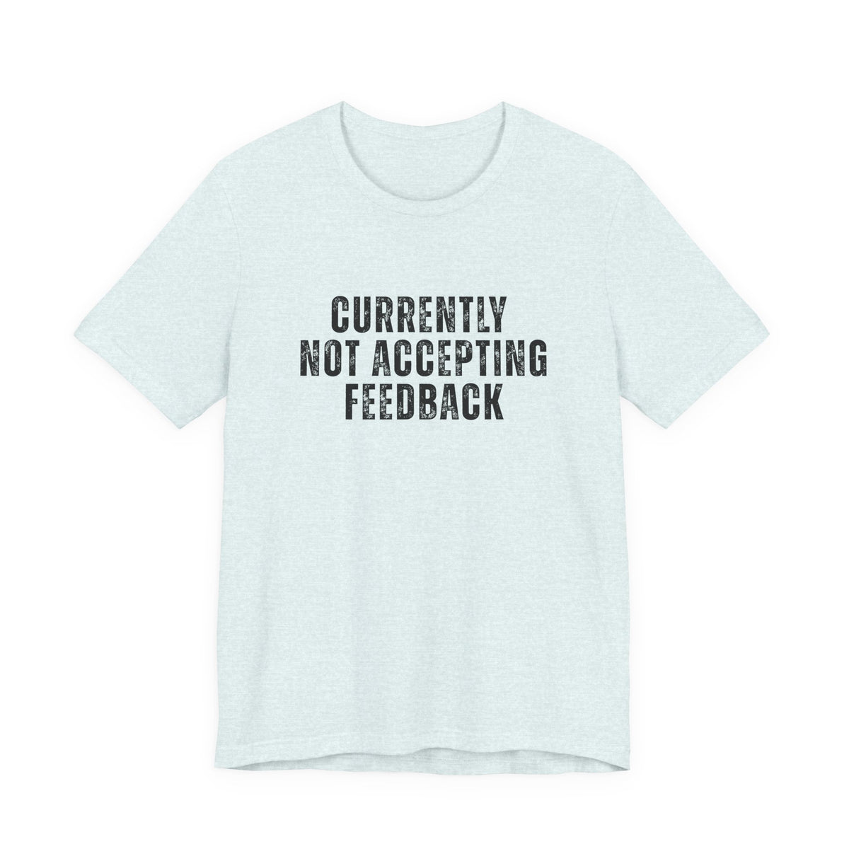 A light heather blue short-sleeve t-shirt with the text 'CURRENTLY NOT ACCEPTING FEEDBACK' printed in distressed black capital letters on the chest, displayed on a solid white background.